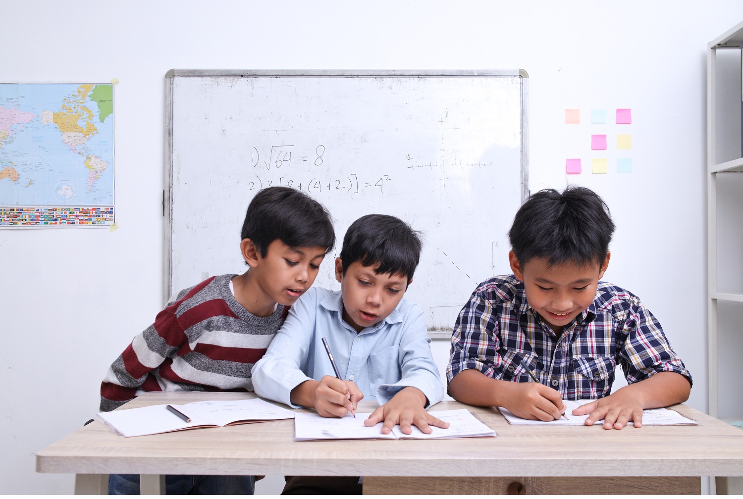 Portrait of diverse cute schoolboy studying together